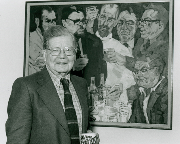 English professor Fred Cogswell standing in front of Bruno Bobak's painting, “Kent’s Punch”