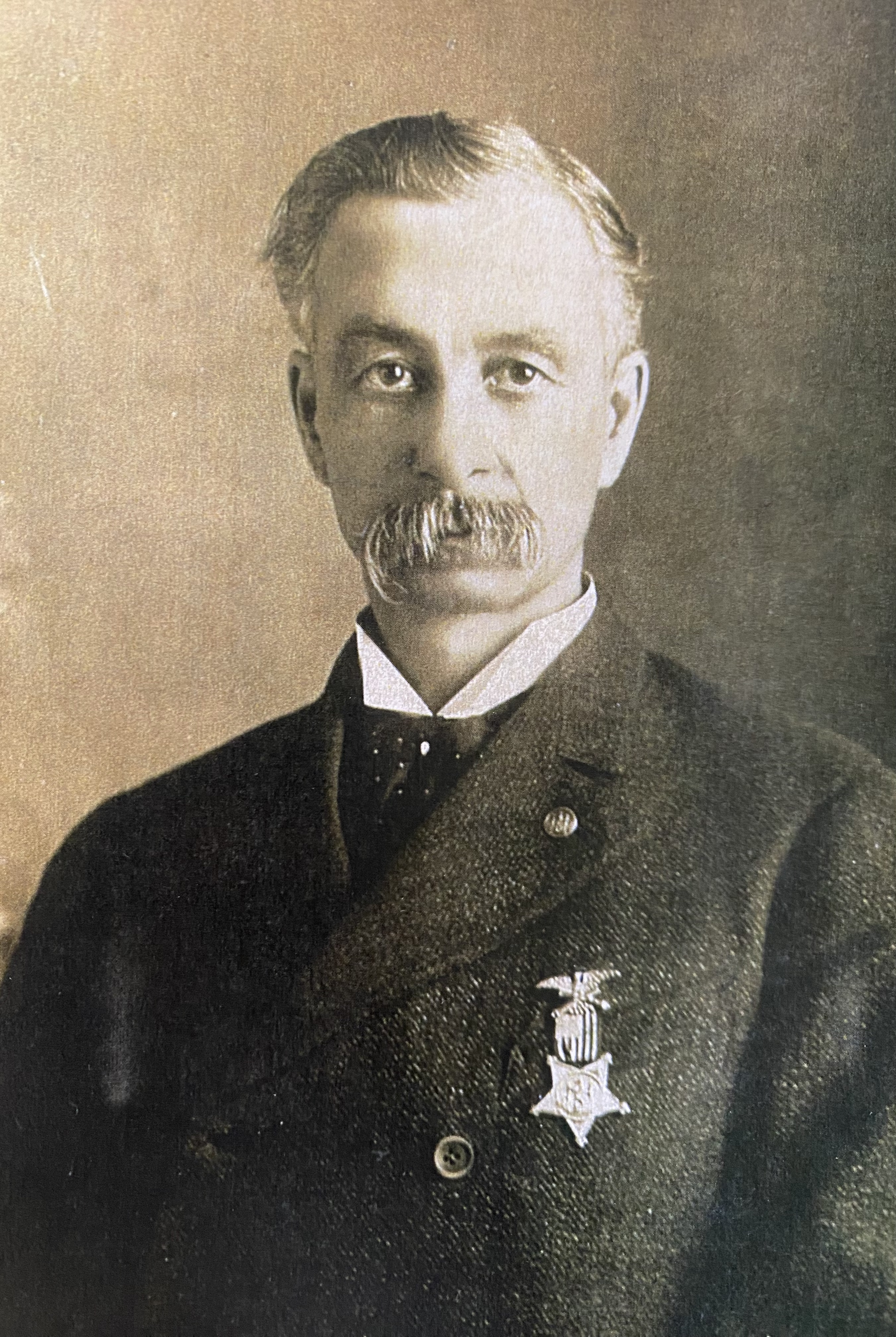 Headshot of John R. Hamilton wearing medal