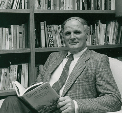 History professor Bill Acheson sitting with book